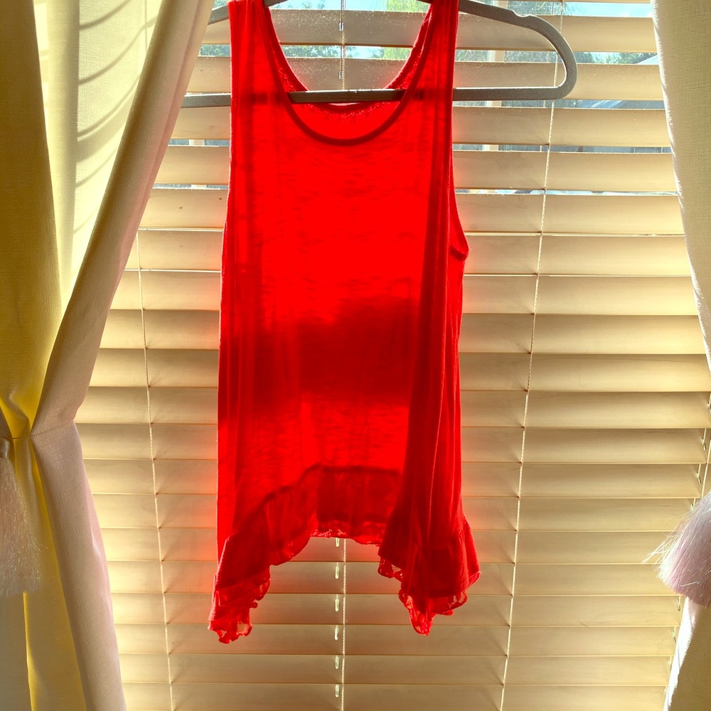 Bright orange top with lace at the bottom🌷